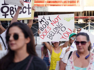 People march together to protest the Supreme Court's decision in the Dobbs v. Jackson Women's Health case on June 24, 2022, in Miami, Florida.