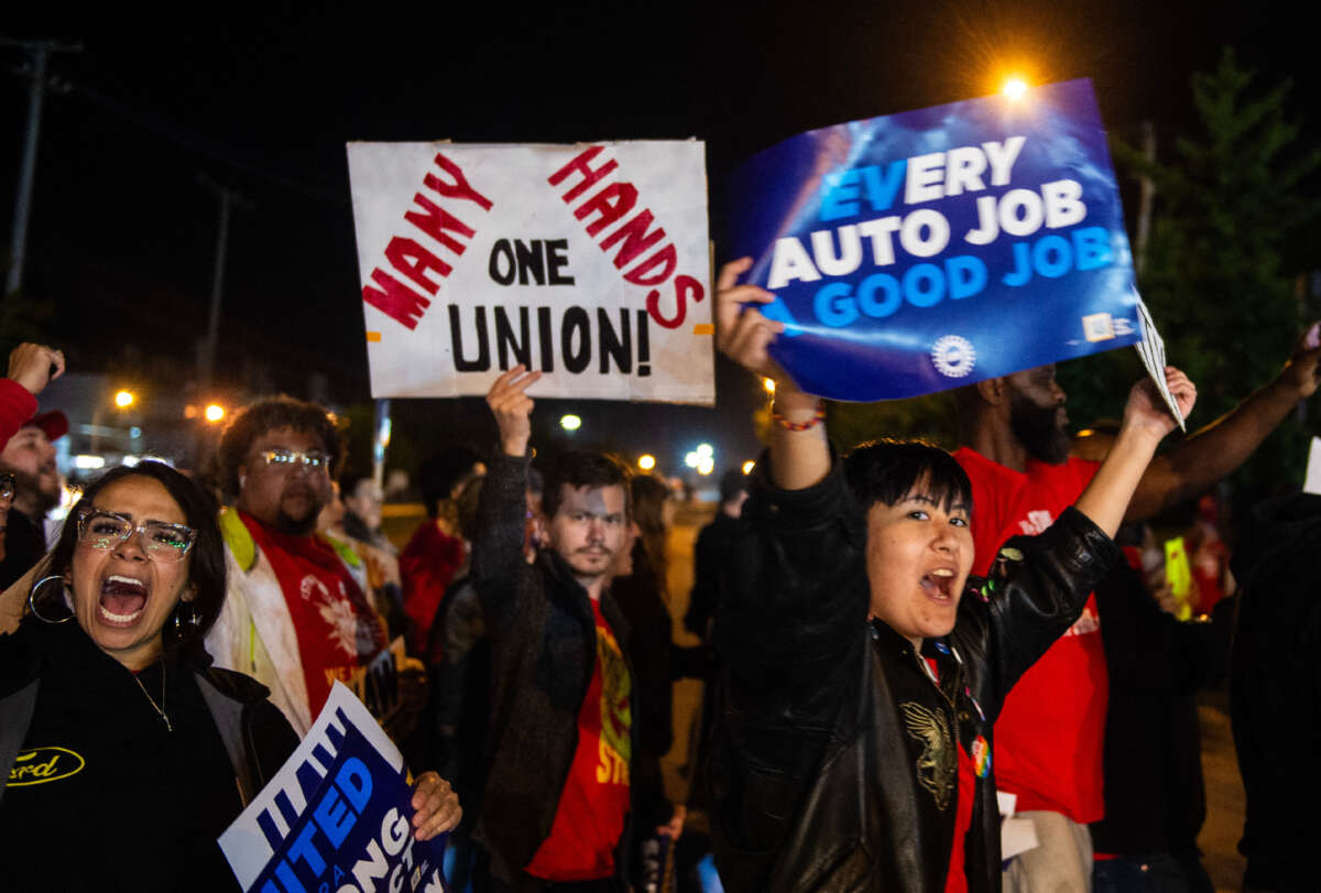Members of the UAW (United Auto Workers) picket and hold signs outside of the UAW Local 900 headquarters across the street from the Ford Assembly Plant in Wayne, Michigan, on September 15, 2023.