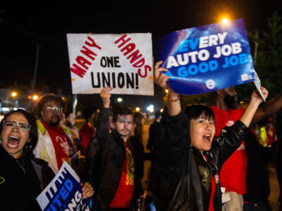 Members of the UAW (United Auto Workers) picket and hold signs outside of the UAW Local 900 headquarters across the street from the Ford Assembly Plant in Wayne, Michigan, on September 15, 2023.