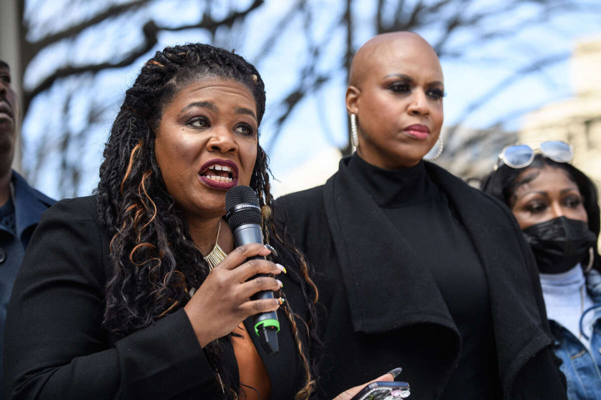 Rep. Cori Bush, left, speaks alongside Rep. Ayanna Pressely during a rally against qualified immunity with the family and supporters of Andrew Joseph III at the Justice Department in Washington, D.C., on March 3, 2022.