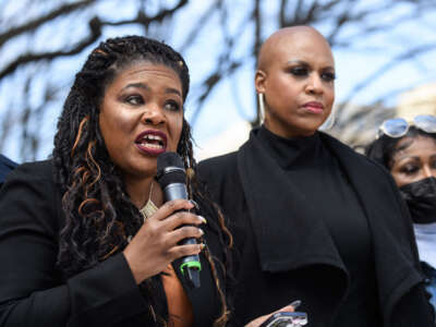 Rep. Cori Bush, left, speaks alongside Rep. Ayanna Pressely during a rally against qualified immunity with the family and supporters of Andrew Joseph III at the Justice Department in Washington, D.C., on March 3, 2022.