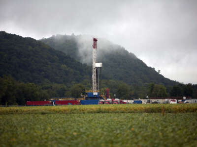 A soybean field lies in front of a natural gas drilling rig on September 8, 2012, in Fairfield Township, Pennsylvania.