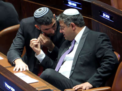 Israeli Knesset (Israeli parliament) member Itamar Ben-Gvir, right, leader of the far-right Otzma Yehudit (Jewish Power) party, speaks with the Likud party's Shlomo Karhi during a session to elect the new speaker of the assembly at its Plenum Hall in Jerusalem on December 13, 2022.