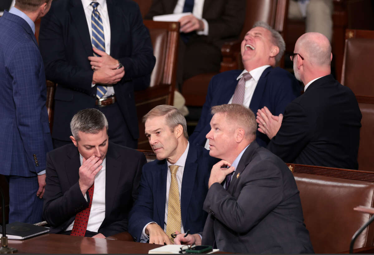 Rep. Jim Jordan, center, talks to a staff member and Rep. Warren Davidson, right, while former Speaker of the House Kevin McCarthy laughs, as the House of Representatives prepares to vote on a new Speaker of the House at the U.S. Capitol Building on October 17, 2023, in Washington, D.C.