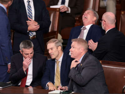 Rep. Jim Jordan, center, talks to a staff member and Rep. Warren Davidson, right, while former Speaker of the House Kevin McCarthy laughs, as the House of Representatives prepares to vote on a new Speaker of the House at the U.S. Capitol Building on October 17, 2023, in Washington, D.C.