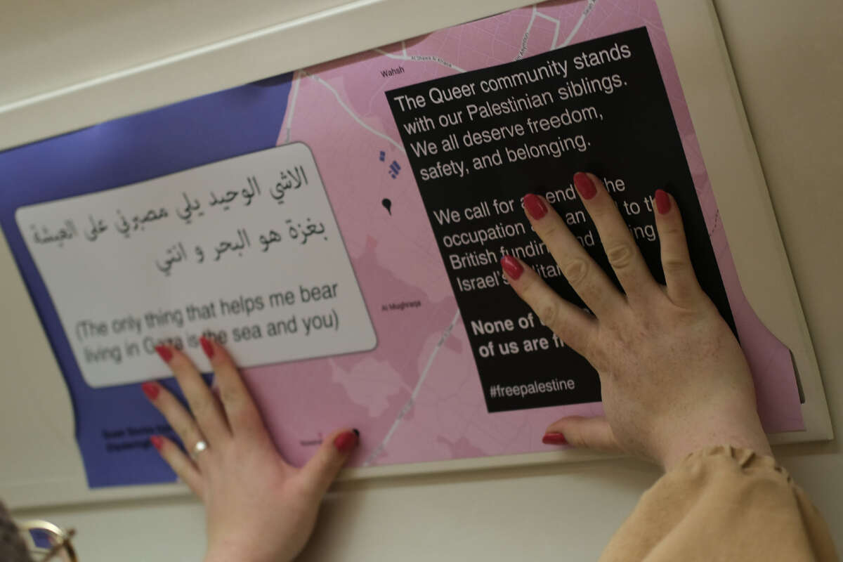 An advertisement on a bus is replaced with stories from queer Palestinians as part of a protest act by The Dyke Project.