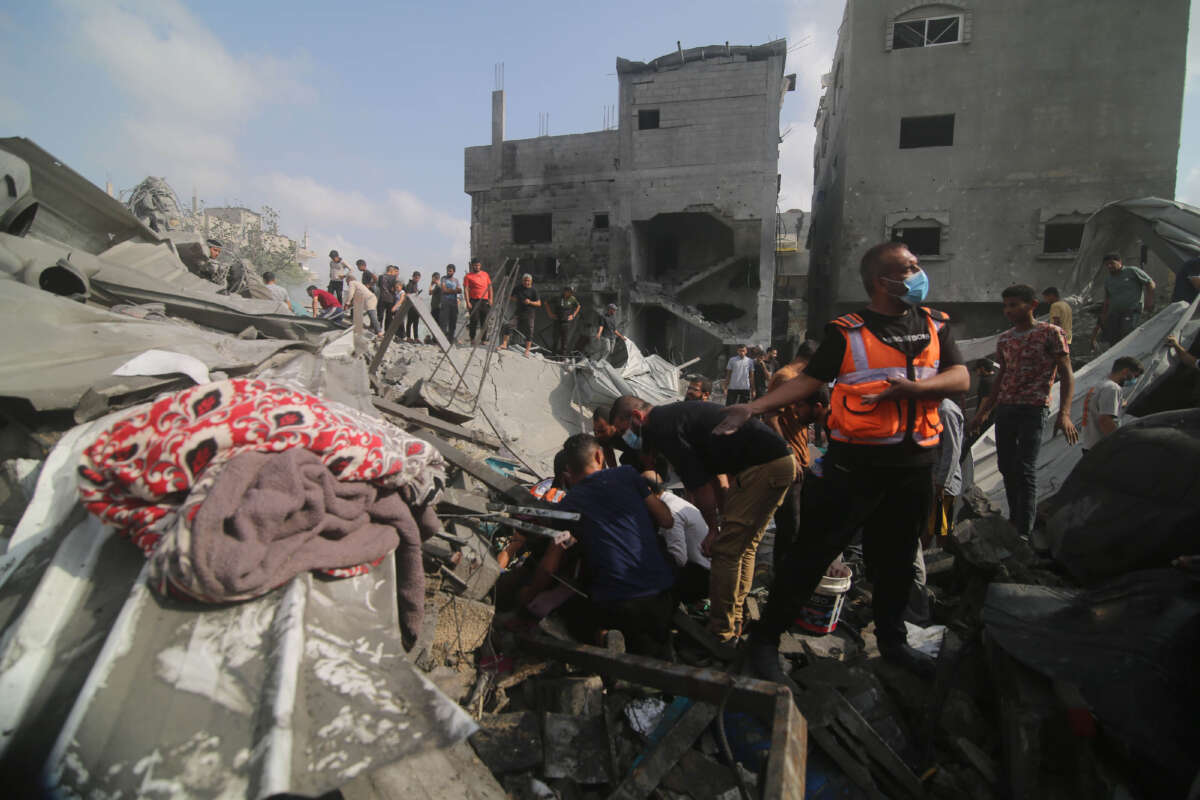 People conduct rescue work after Israeli airstrikes in the southern Gaza Strip city of Rafah on October 22, 2023.