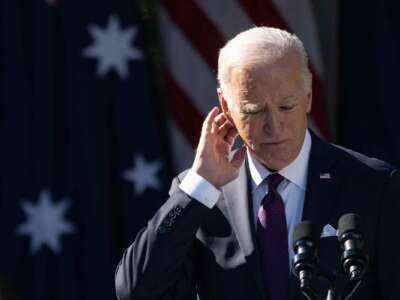 Joe Biden scratches his ear