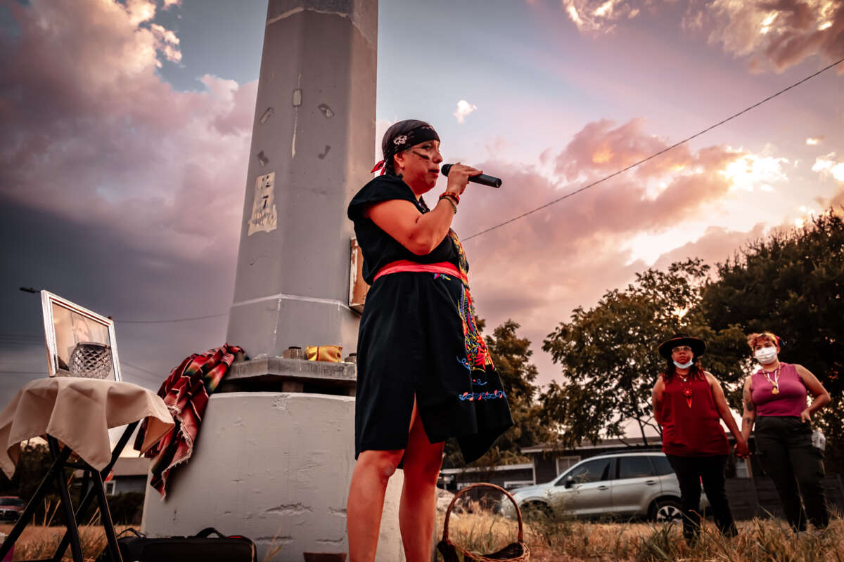 Maria Turvin speaks at a vigil for Albert Garcia.