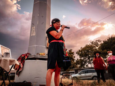 Maria Turvin speaks at a vigil for Albert Garcia.