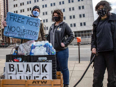 Food Not Bombs volunteers distribute free food and supplies at a protest