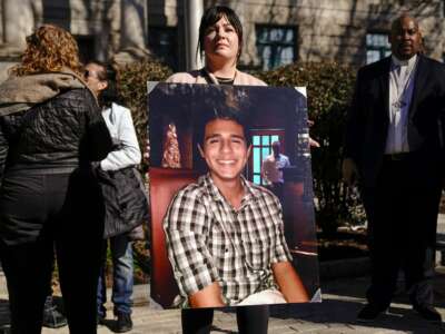 Sister-in-law, Fiona Paez, holds a photograph of environmental activist Manuel Esteban Paez Terán, better known as Tortuguita, during a press conference in Decatur, Georgia on February 6, 2023.