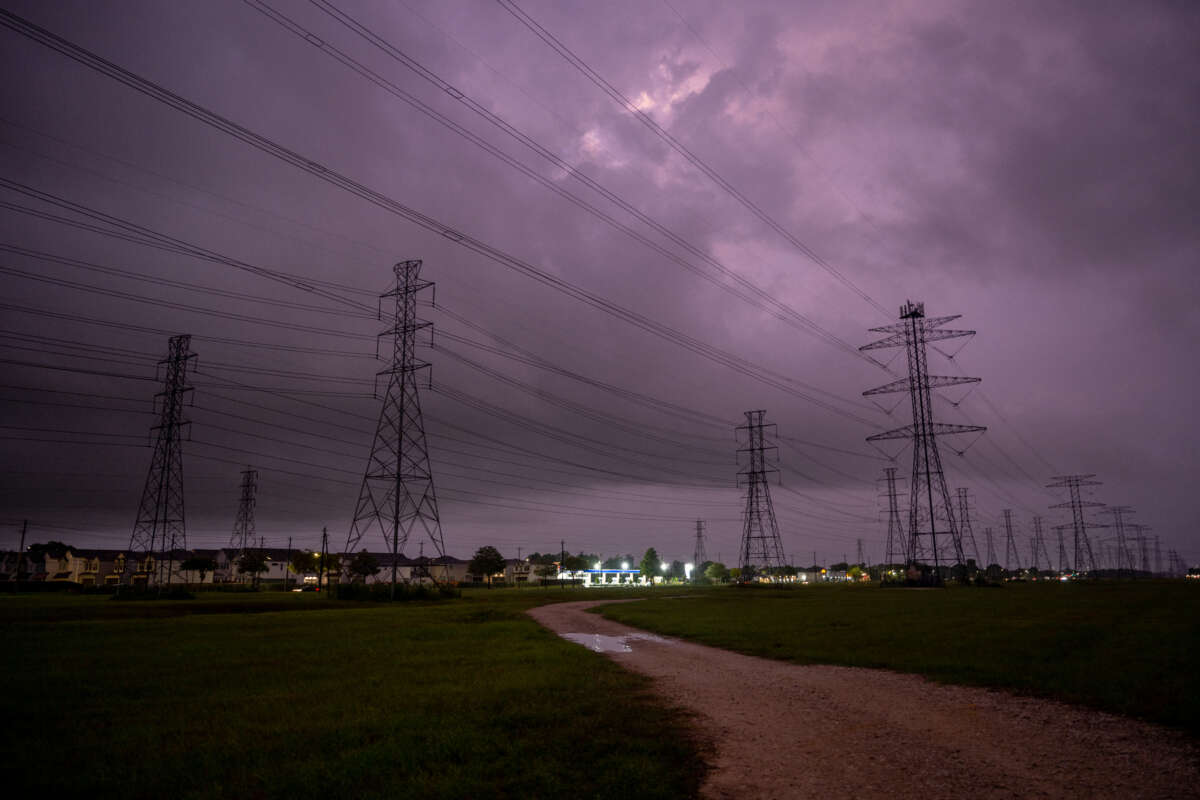 Transmission towers are seen near a CenterPoint Energy power plant in Houston, Texas, on July 11, 2022.