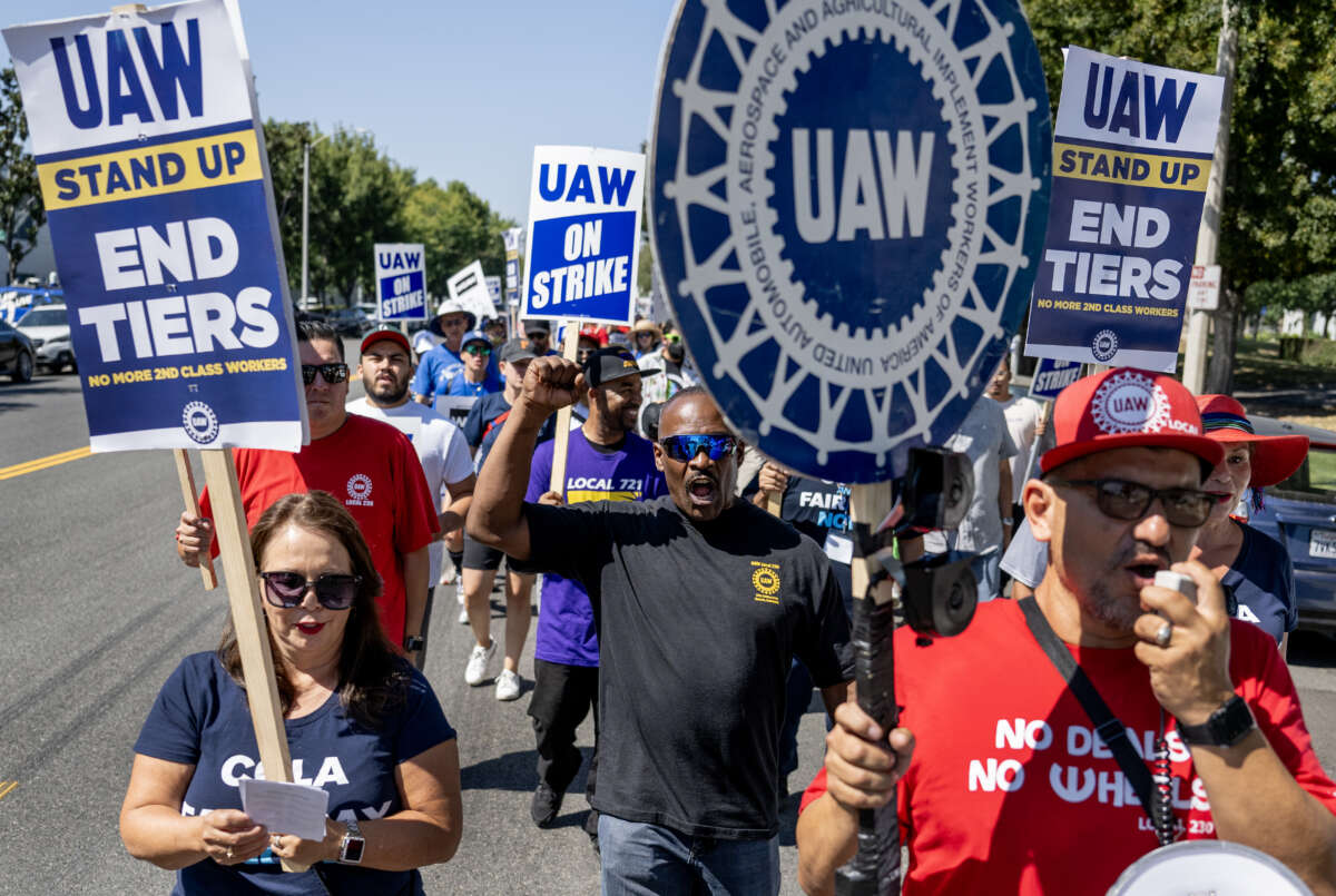 Striking United Auto Workers march in front of the Stellantis Mopar facility in Ontario, California