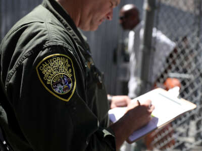 A California Department of Corrections and Rehabilitation officer logs condemned inmates who are leaving the exercise yard at San Quentin State Prison's death row on August 15, 2016, in San Quentin, California.