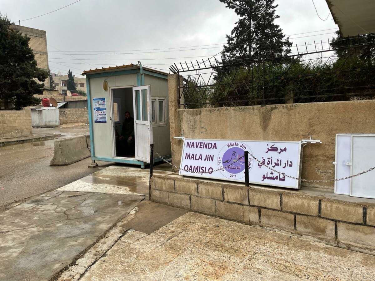 A sign and Asayiş defense post outside of Mala Jin during 2023 in Qamishlo, a city in northeast Syria.