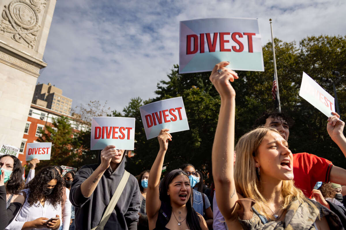 Students from New York University hold signs that read "Divest" and chant during a rally as students call for a ceasefire in Gaza, in New York, on October 25, 2023.