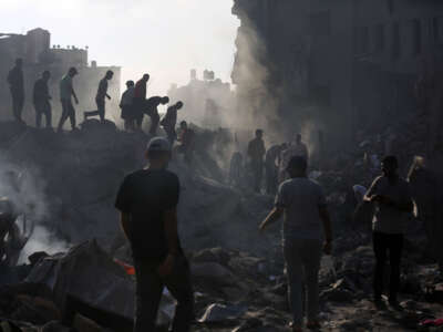 Civilians conduct search and rescue operations and debris removal work at the heavily damaged buildings after Israeli attacks at Al Bureij Refugee Camp as Israeli attacks continue on the 27th day in Gaza City, Gaza, on November 2, 2023.