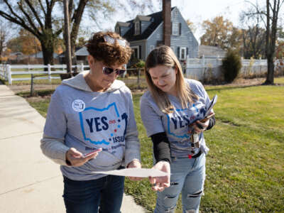 Abortion rights advocates look at a map of a neighborhood before canvassing ahead of the general election in Columbus, Ohio, on November 5, 2023.