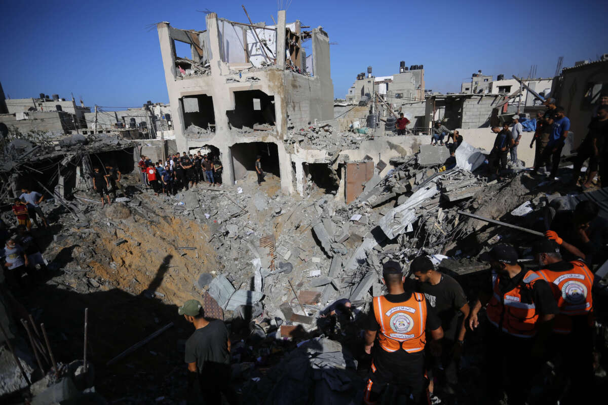 Locals and civil defense teams conduct search and rescue operations after an Israeli attack hit a family residence in Deir al-Balah, Gaza, on November 7, 2023.
