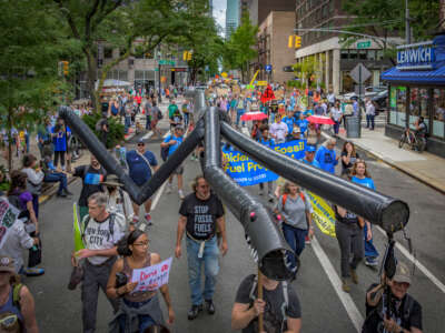 Participants march with an inflatable pipeline monster during the March to End Fossil Fuels in New York City, on September 17, 2023.