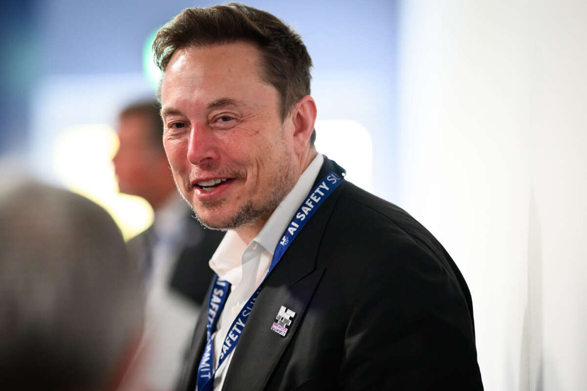 Elon Musk speaks with other delegates during day one of the AI Safety Summit at Bletchley Park on November 1, 2023, in Bletchley, England.