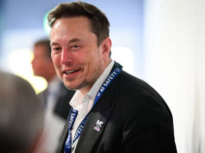 Elon Musk speaks with other delegates during day one of the AI Safety Summit at Bletchley Park on November 1, 2023, in Bletchley, England.