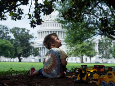 A child plays on the east front lawn of the U.S. Capitol on July 12, 2021.