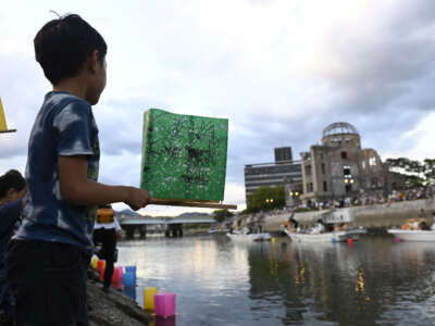 People attend the Peace Message Lantern Floating Ceremony at the Hiroshima Peace Memorial Park to pay tribute to the atomic bomb victims in Hiroshima, Japan, on August 6, 2023.