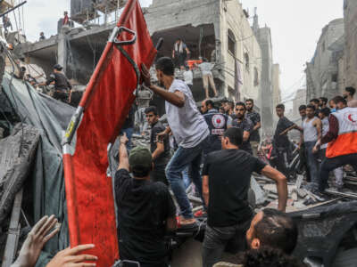 Emergency responders and volunteers search the destroyed house of the Al-Ghouti family for the injured and dead people following an Israeli airstrike, on November 11, 2023, in Rafah, Gaza.