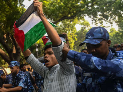 Indian police personnel detain an activist during a protest in support of Palestinians in Gaza, amid the conflict between Israel and Hamas in New Delhi, India, on October 27, 2023.