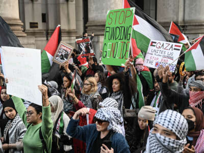 Protesters with flags and banners gather to show their solidarity with Palestinians and to condemn Israeli attacks over Gaza, in New York, on November 7, 2023.