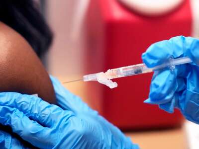 A medical worker administers a dose of the covid-19 vaccine