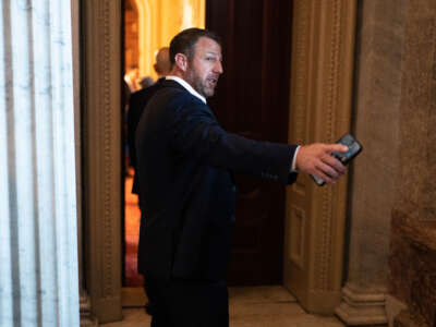 Sen. Markwayne Mullin talks with reporters in the U.S. Capitol as the Senate works on the debt limit bill on June 1, 2023.