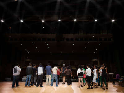 School play, teens rehearsing on stage, facing away