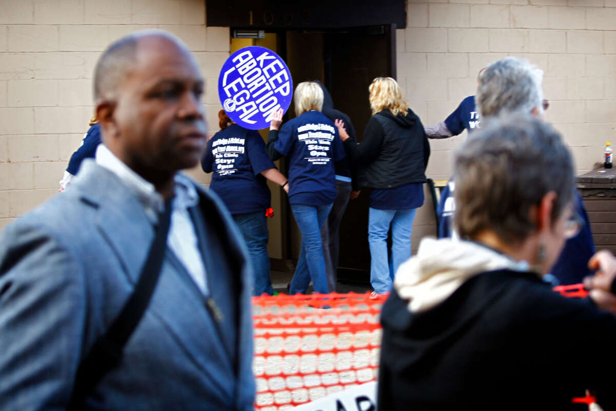 NOW activists shield patients from anti-abortion activists outside the Abortion and Contraceptic Clinic in Omaha, Nebraska, in August, 2009.