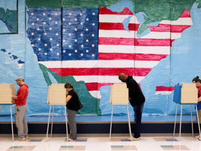 Voters fill out their ballots at a polling station on November 7, 2023.