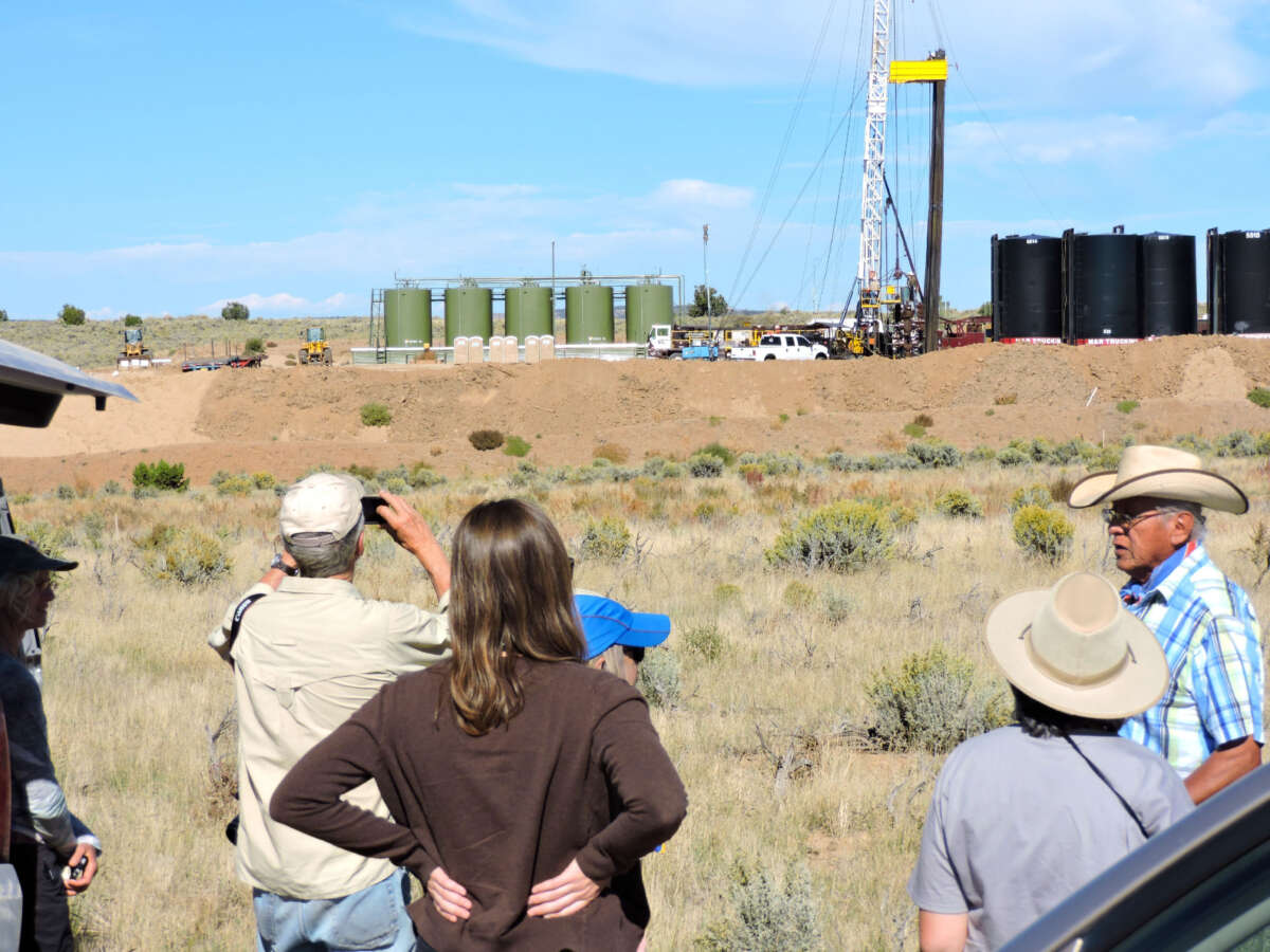 People observe a fracking site in the Greater Chaco Region on September 27, 2015.