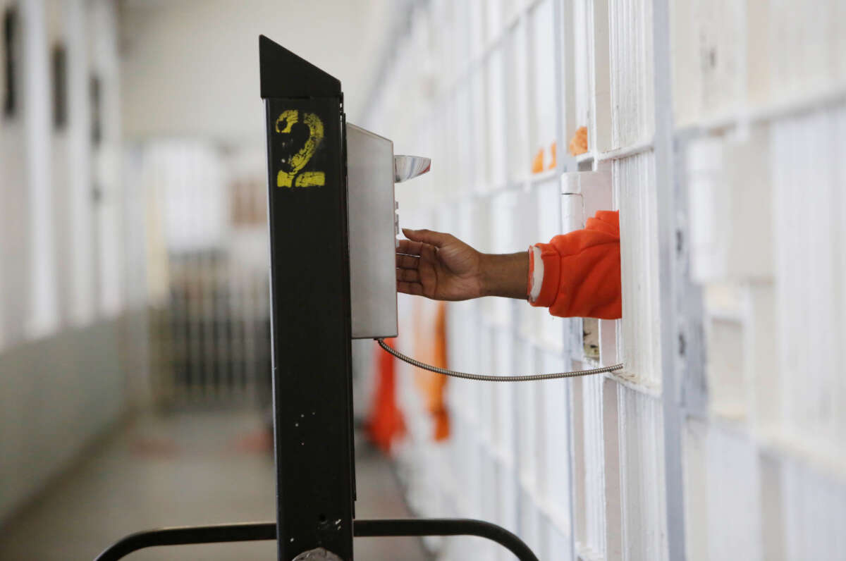 An inmate uses a rollaway phone at the jail at the Hall of Justice on December 1, 2015, in San Francisco, California.