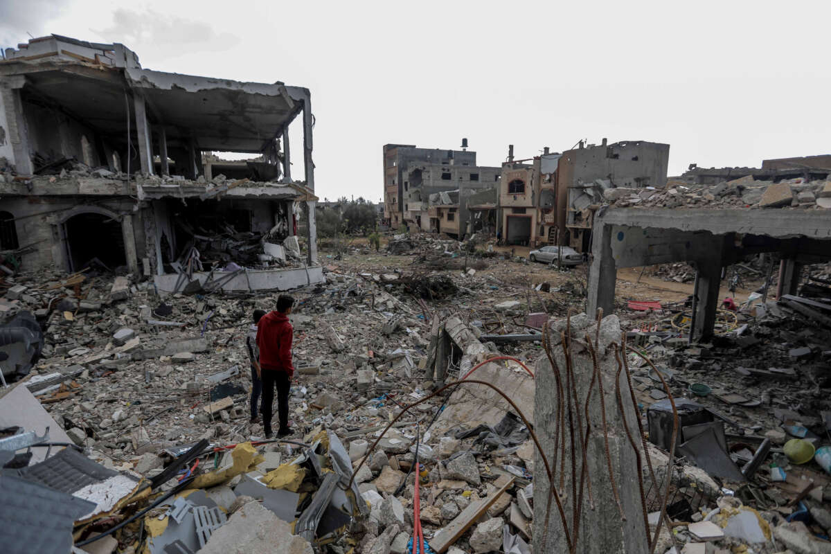 Palestinian citizens inspect the effects of destruction caused by air strikes on their homes in the Khuza’a area on November 27, 2023, in Khan Yunis, Gaza.