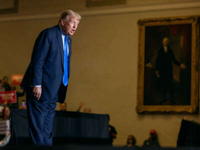 Former President Donald Trump yells to the crowd before delivering remarks during a campaign event on November 11, 2023, in Claremont, New Hampshire.