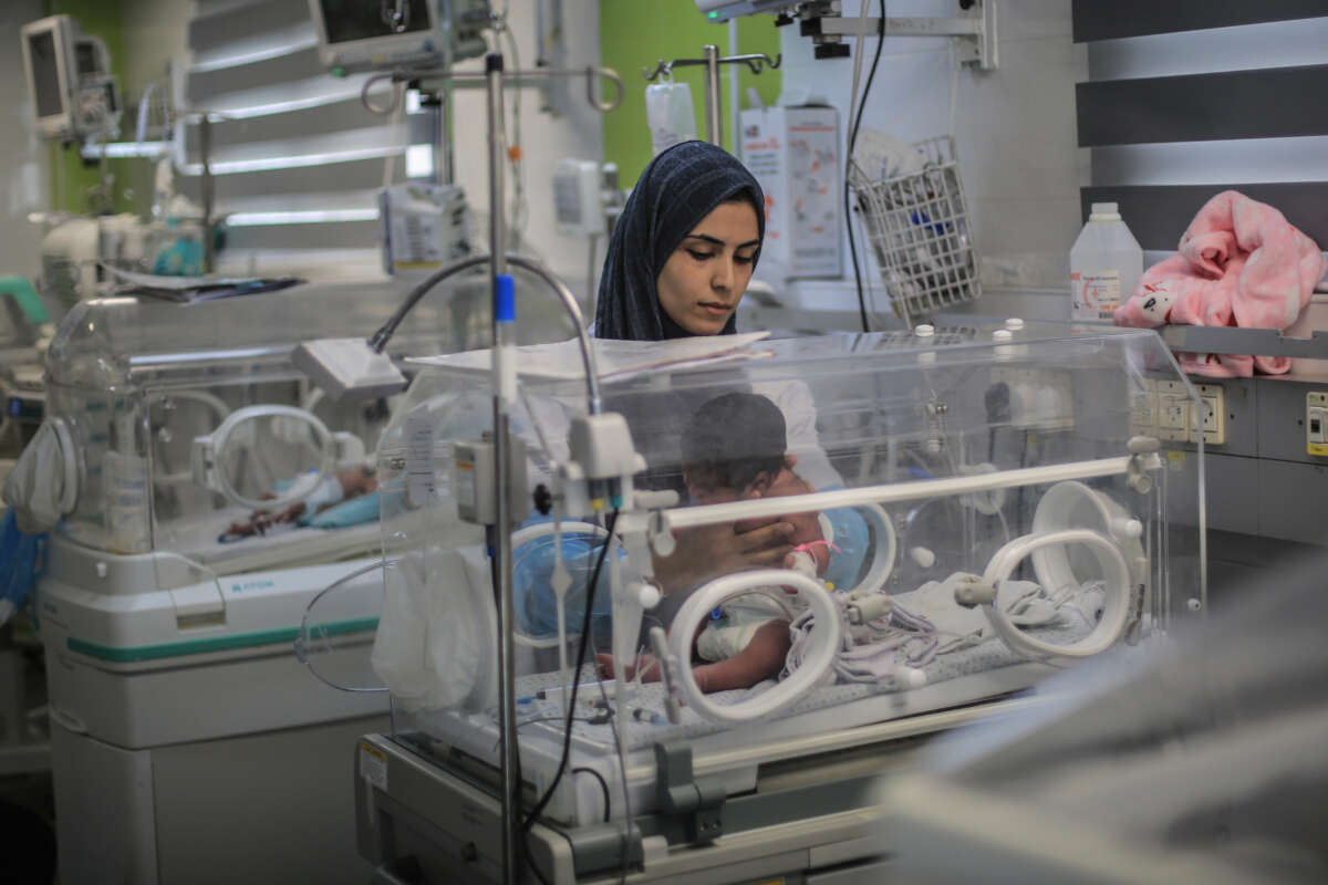 A newborn infant receives care inside an incubator in Gaza