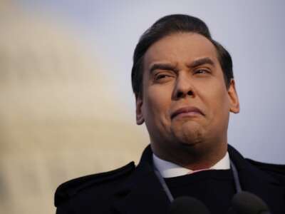 Rep. George Santos talks to reporters outside the U.S. Capitol on November 30, 2023 in Washington, D.C.