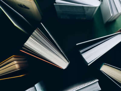 Top down view of books standing on green surface