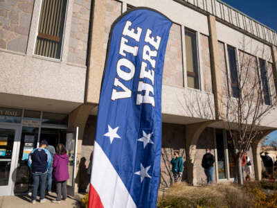 A line of voters wrap around the sidwalks outside West Allis City Hall, a suburb just to the west of Milwaukee on November 3, 2020.