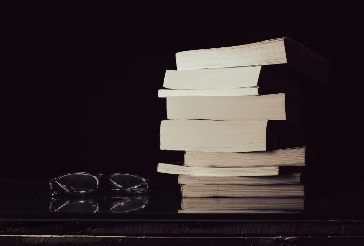 Stack of books with reading glasses