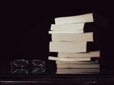 Stack of books with reading glasses