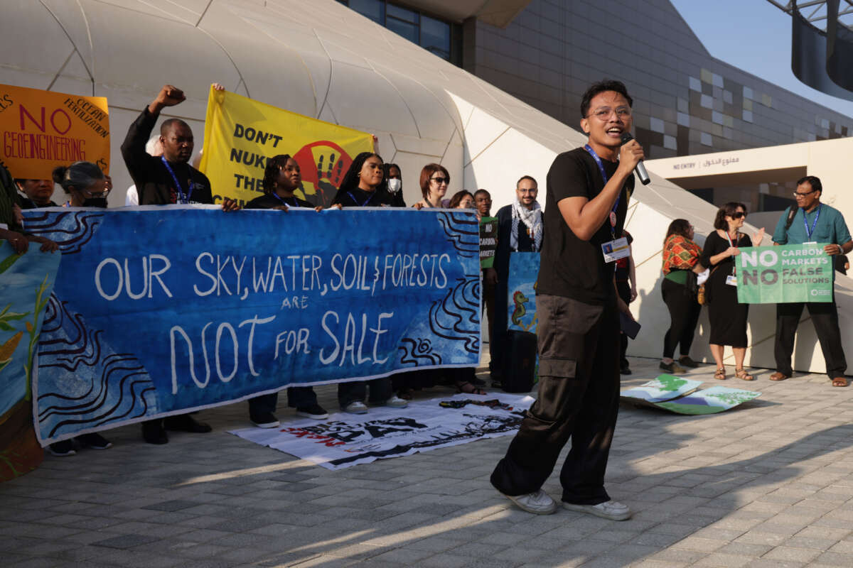 Activists protest against what they call the sham of carbon offsetting on day eight of the COP28 climate conference at Expo City Dubai on December 8, 2023, in Dubai, United Arab Emirates.
