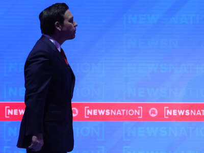 Republican presidential candidate Florida Gov. Ron DeSantis walks across the stage during a commercial break in the NewsNation Republican Presidential Primary Debate at the University of Alabama Moody Music Hall on December 6, 2023, in Tuscaloosa, Alabama.