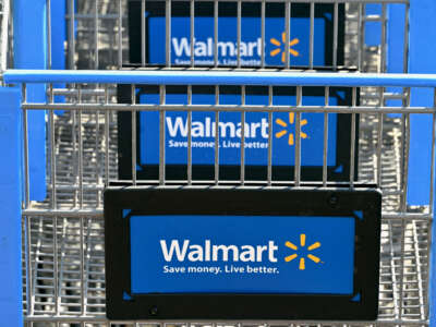 Shopping carts with the Walmart logo are seen outside a Walmart store in Burbank, California, on August 15, 2022.